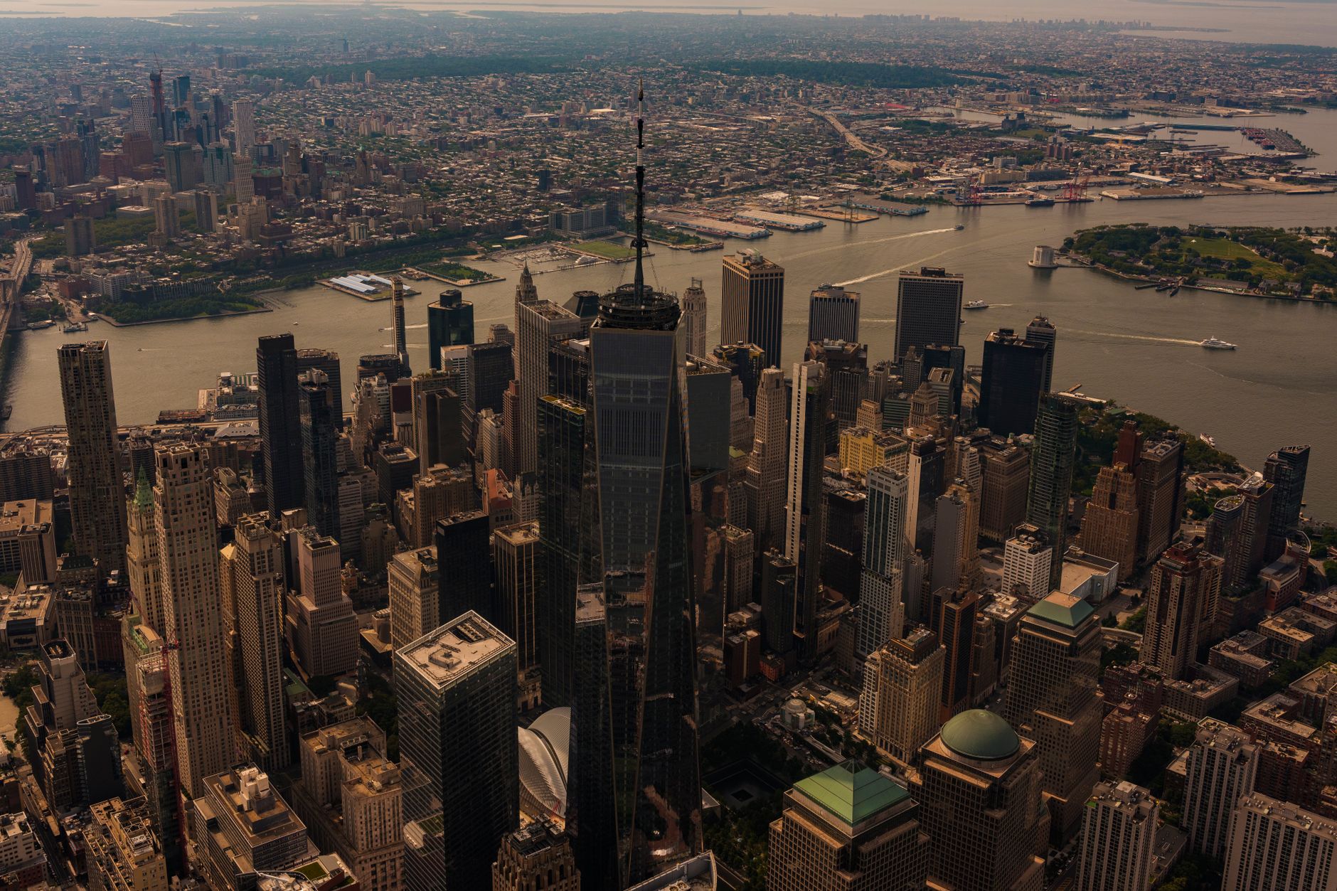 A breathtaking aerial view of New York City skyline with One World Trade Center prominently visible.