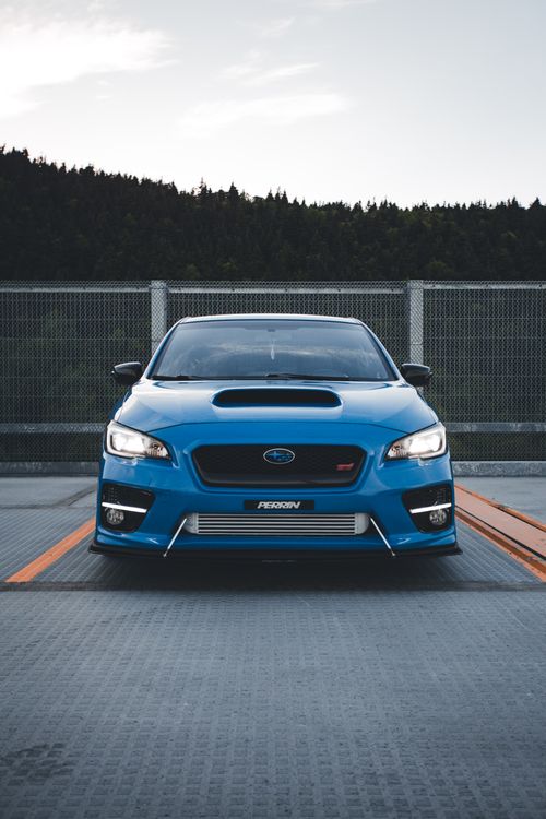 Free Front view of a blue Subaru car parked outdoors, showcasing its design and style. Stock Photo