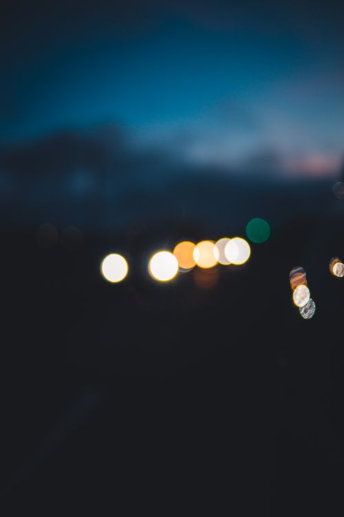 Free Abstract image featuring defocused bokeh lights against a dark night sky. Stock Photo