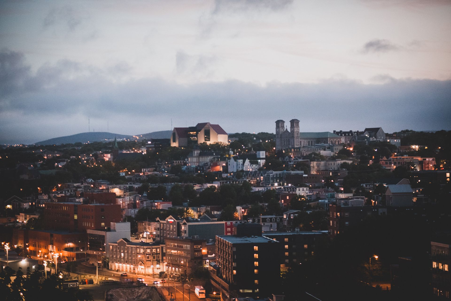 Aerial view of a city's downtown district at twilight, showcasing urban architecture.