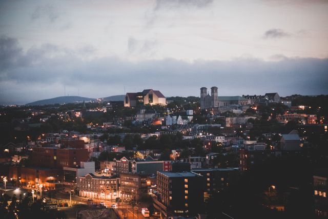 Aerial view of a city's downtown district at twilight, showcasing urban architecture.