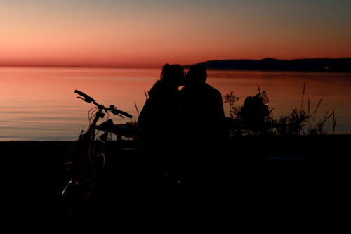 Silhouette of 2 People Riding Motorcycle during Sunset