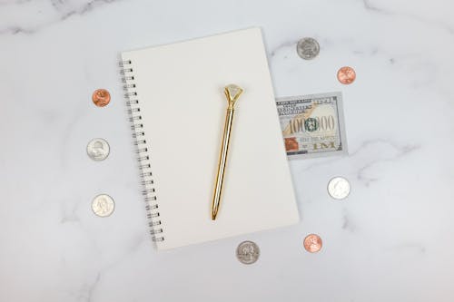 Free Getting Paid Money and Notebook Stock Photo