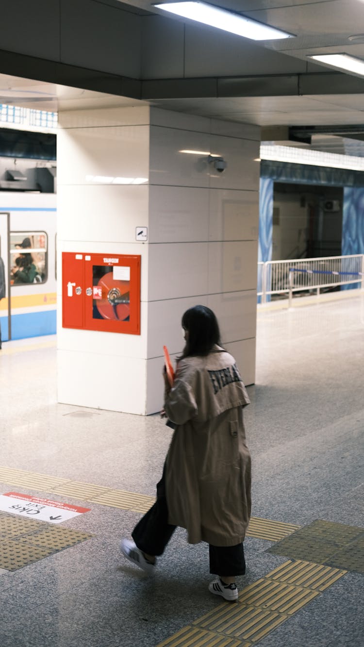 Woman In Coat On Subway Station