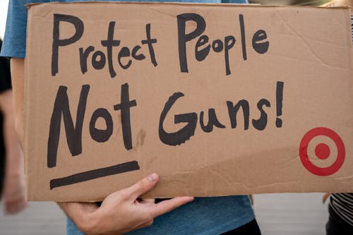 Close-up of Person Holding a Sign at a Protest against Gun Violence 