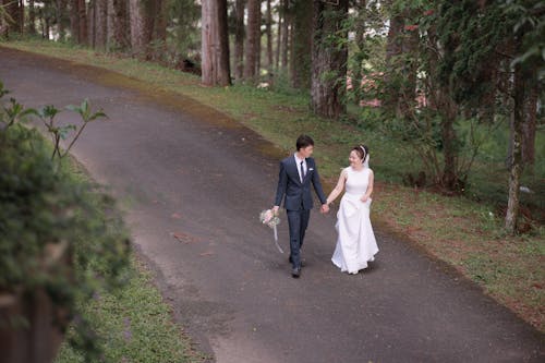 A Groom and Bride Walking Together 