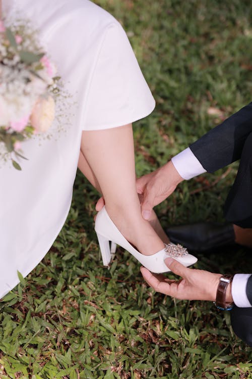 Groom Touching Bride Shoe 