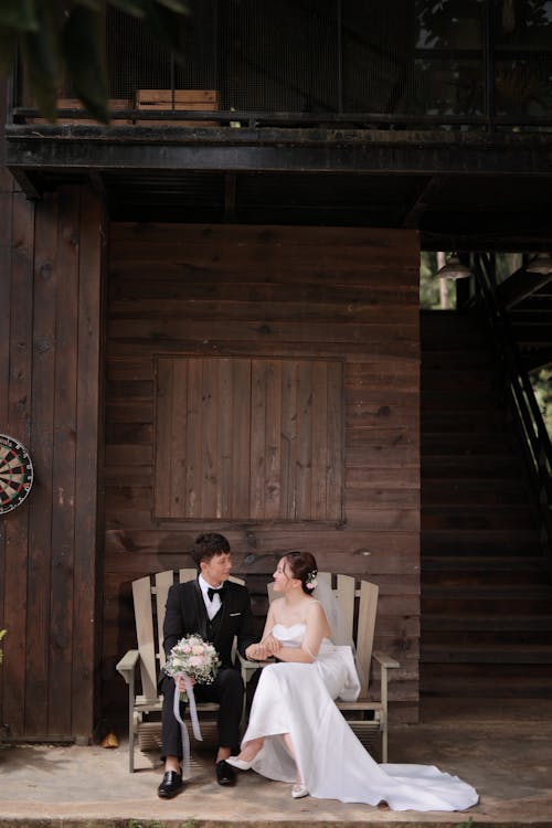 A Man in Black Suit and a Woman in White Wedding Dress
