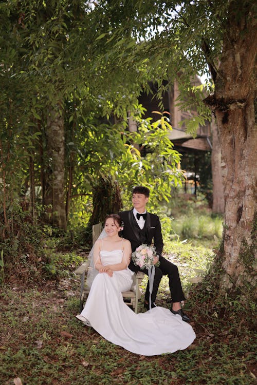 A Woman in Wedding Dress and Man in Black Suit