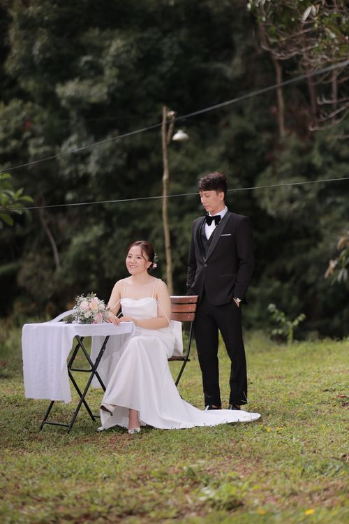 Free A joyful Vietnamese couple celebrates their outdoor wedding, showcasing their love in a natural setting. Stock Photo