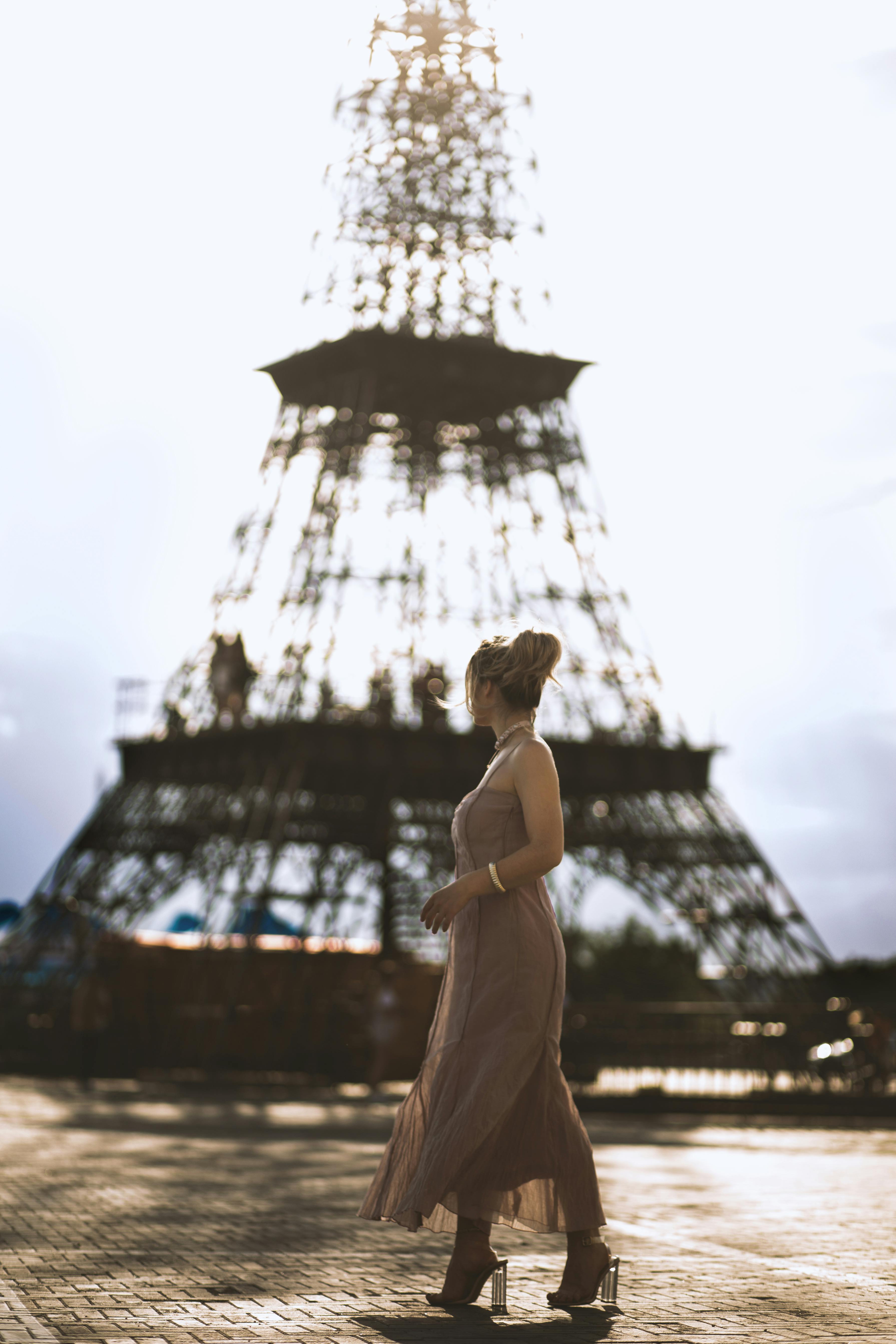 Woman Standing Near Eiffel Tower · Free Stock Photo