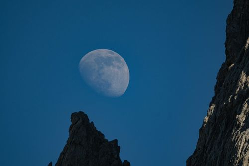 Free Captivating view of the moon above cliffs in a serene night sky. Stock Photo