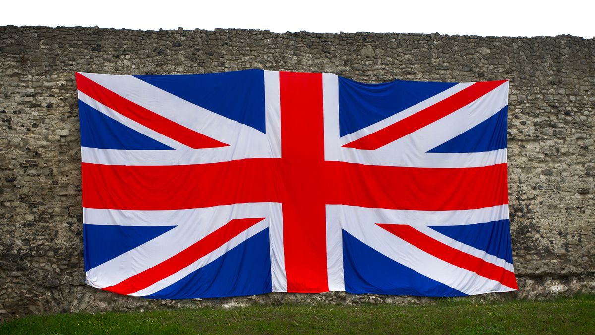 Union Jack flag draped over a historic stone wall, symbolizing British heritage in Rochester, England.
