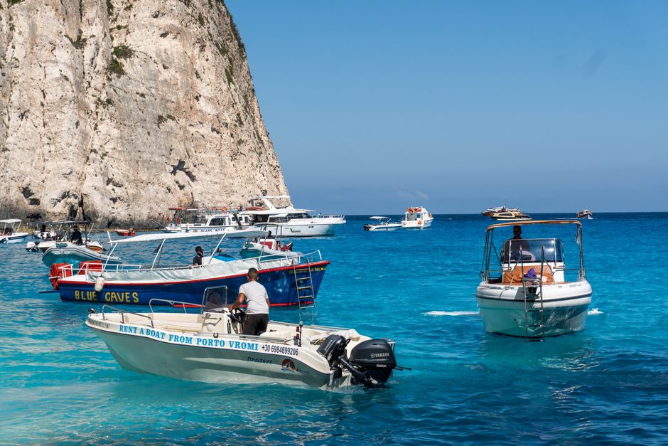 Speedboat approaching the glowing Blue Cave on Biševo Island, Croatia