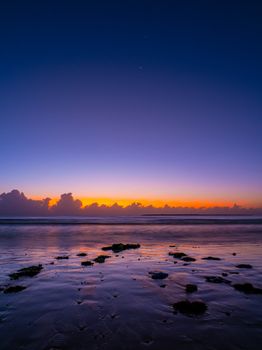 Tranquil sunset over Dar es Salaam beach with vivid colors and calm waters.