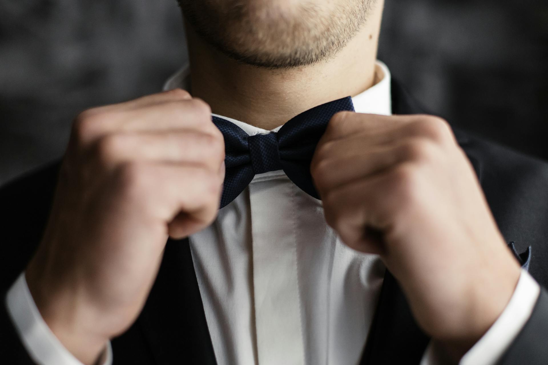 Close-up of Groom Touching Bow