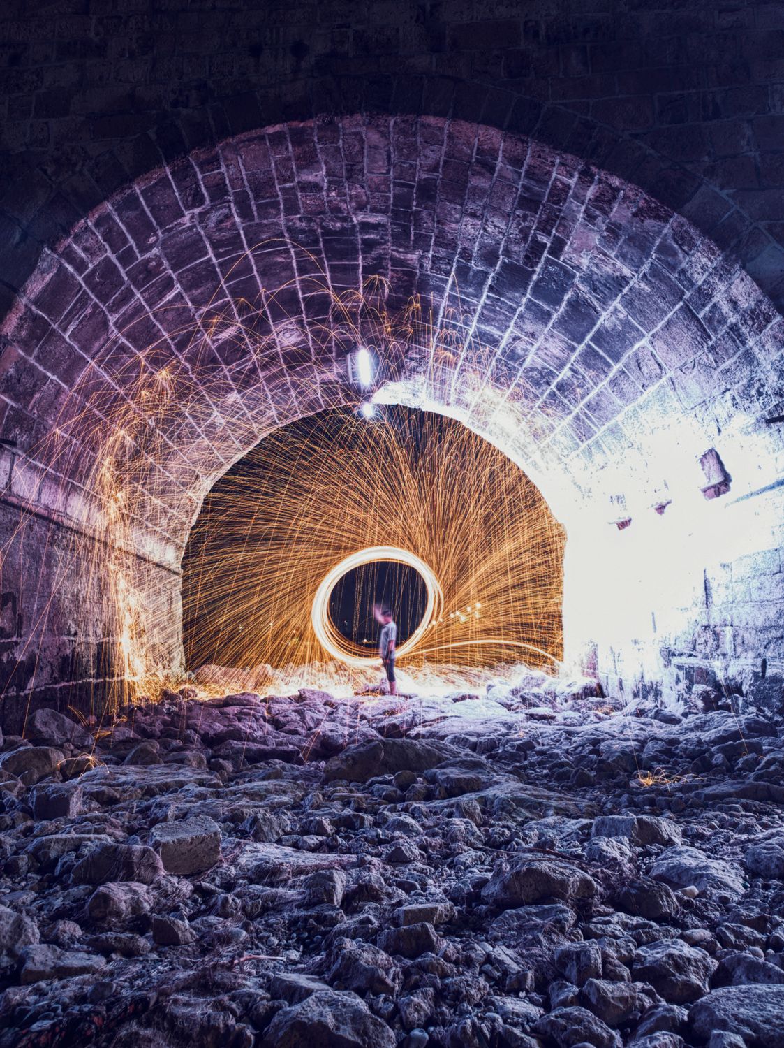 Person Standing in a Tunnel with Fireworks Display · Free Stock Photo
