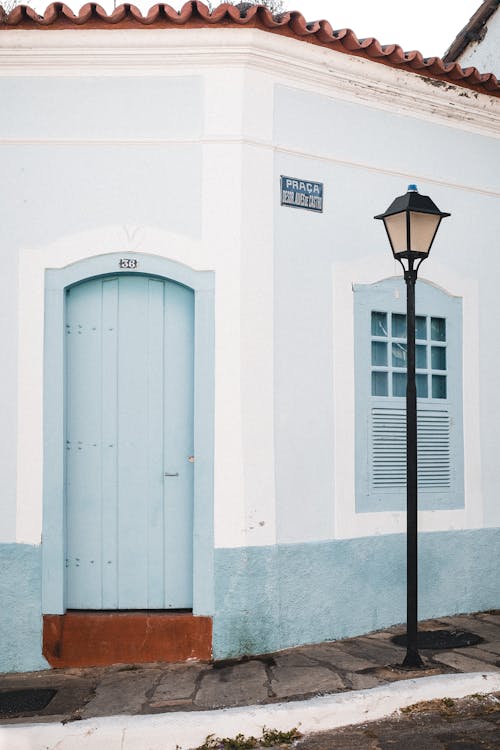 Black Street Light Near Blue Wooden Door