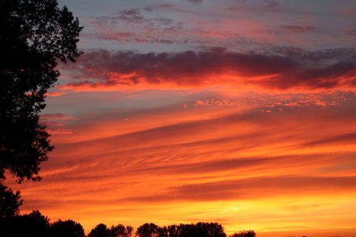 Free Dramatic sunset with vivid orange clouds over a Belgian landscape. Stock Photo