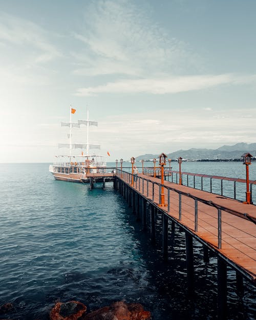 Ship with Sails near Pier