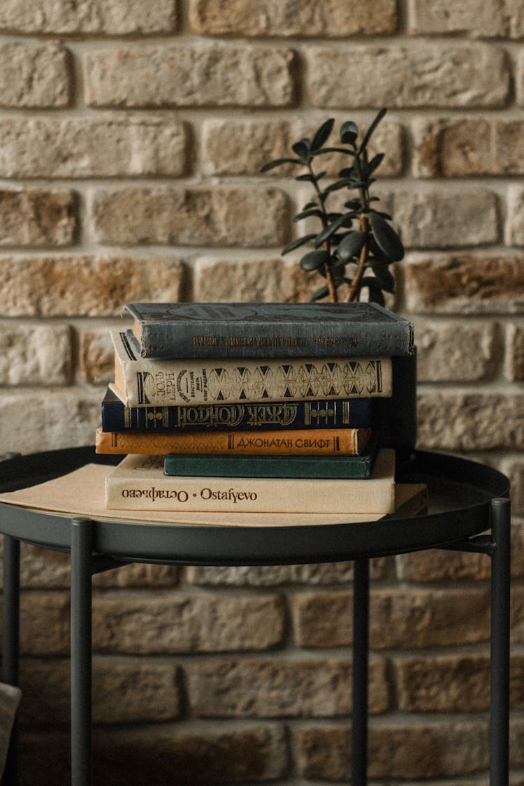 A Stack Of Books On A Black Table