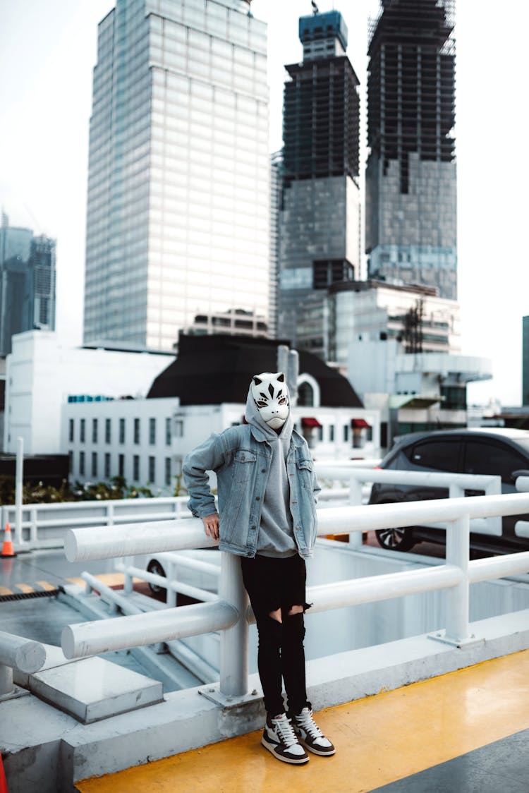 Masked Person With Leaning On Railing On City Street