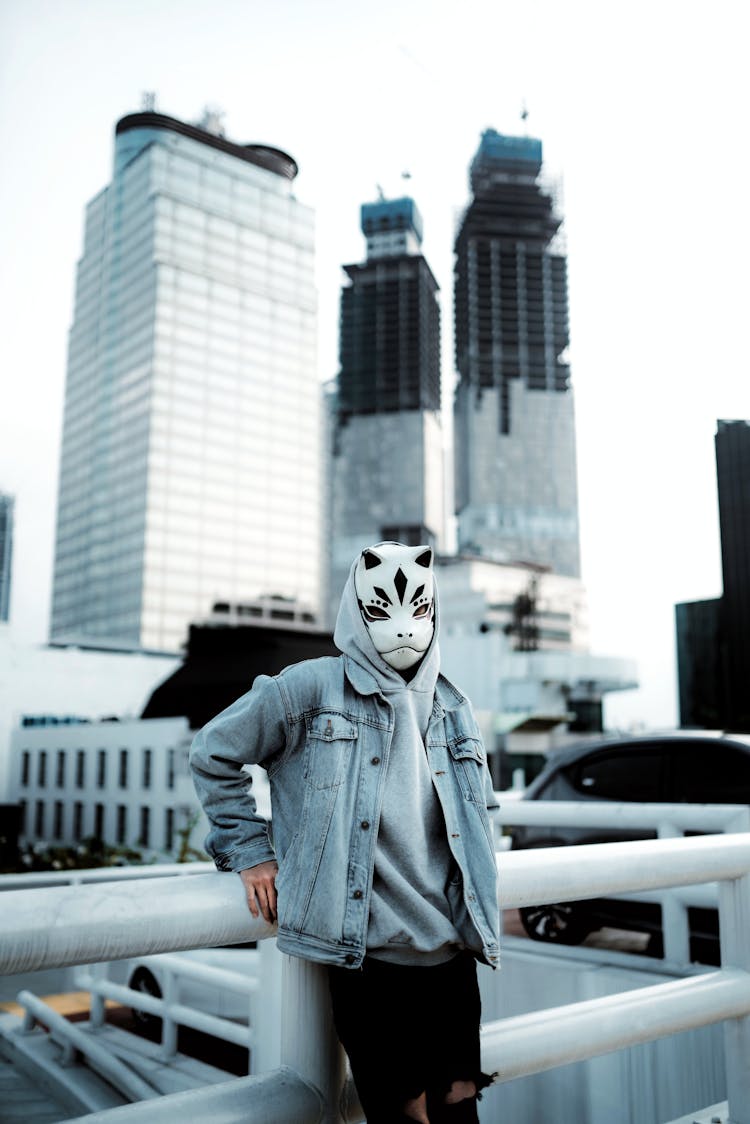 Masked Person With Leaning On Railing On City Street