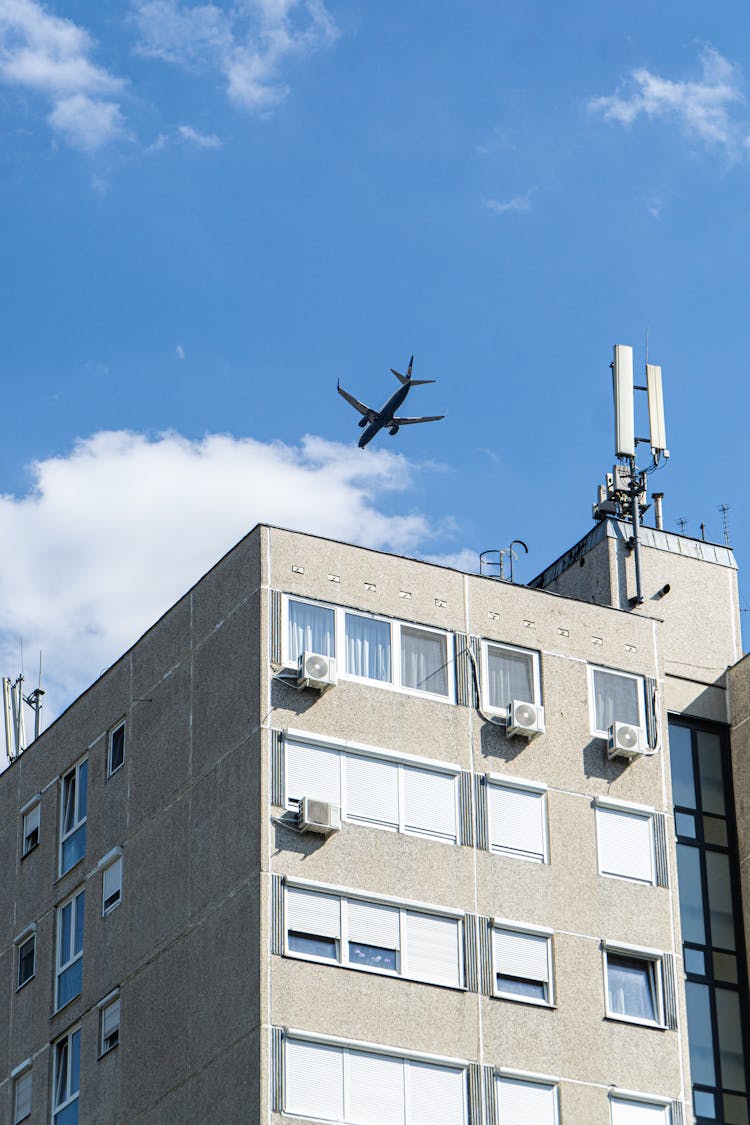 Photo Of An Airplane Above A Building