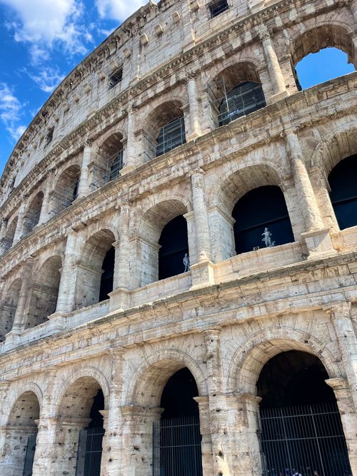 Free Close-up of the iconic Colosseum in Rome against a clear blue sky. Stock Photo