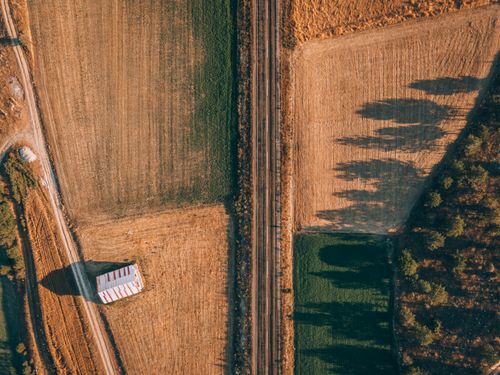 Free Drone shot of Alpagut, Turkey, showcasing fields, railway, and rural scenery. Stock Photo