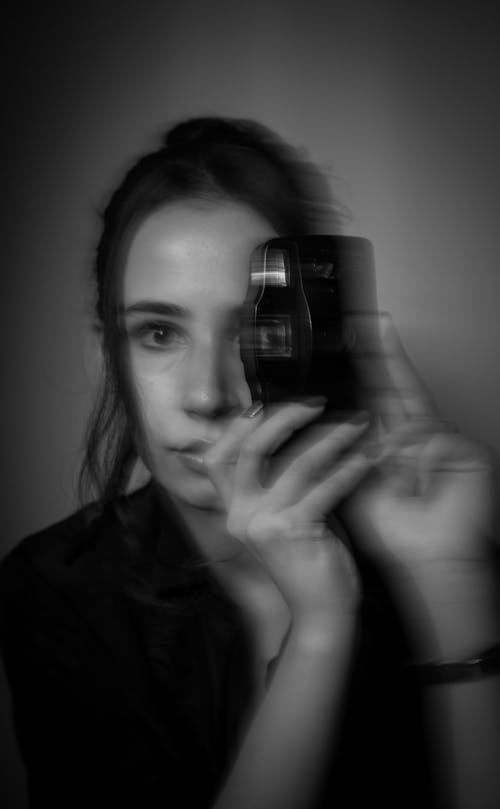 Woman Making Picture with Retro Camera