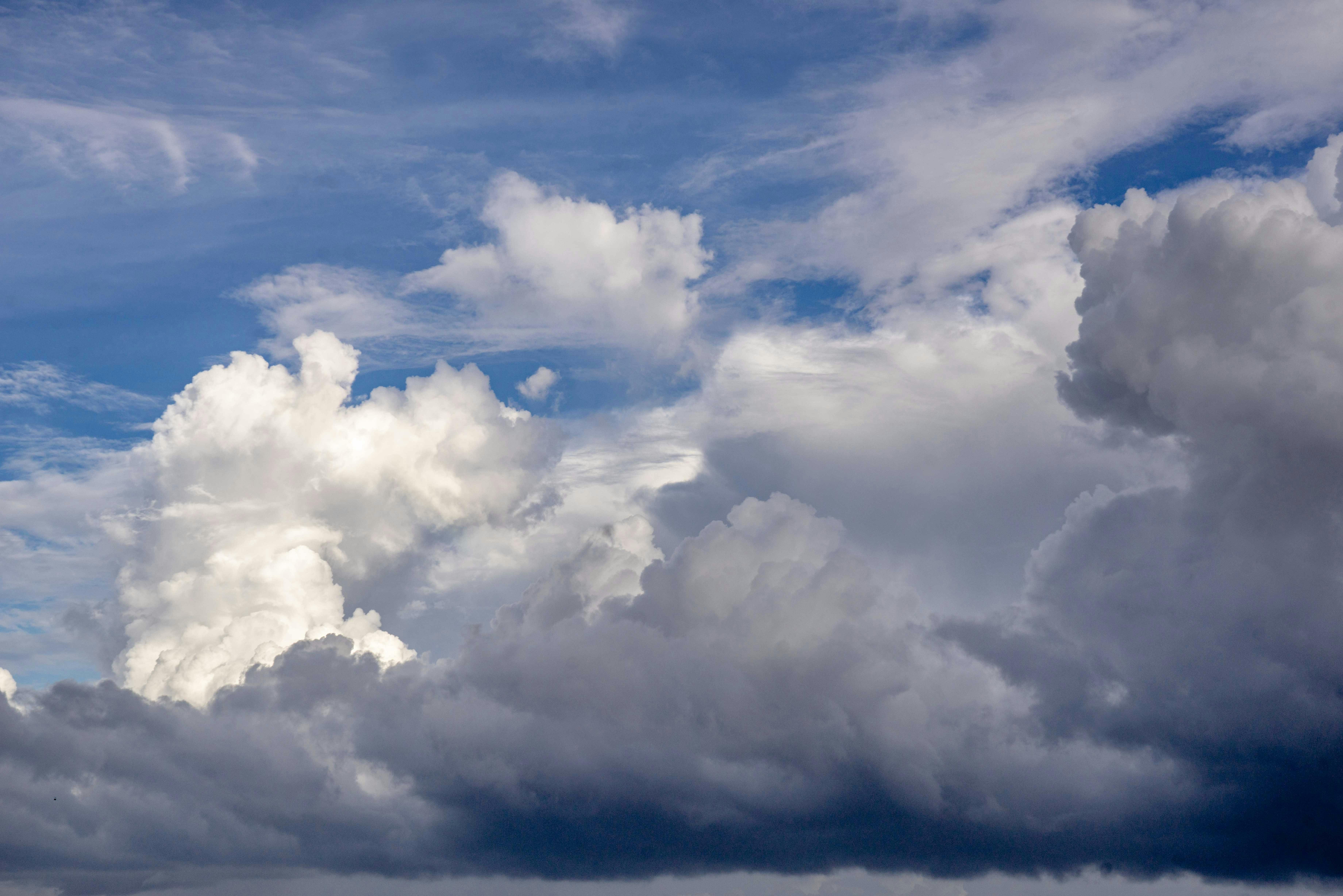 A stunning display of fluffy cloud formations against a bright blue sky, capturing the beauty of nature.