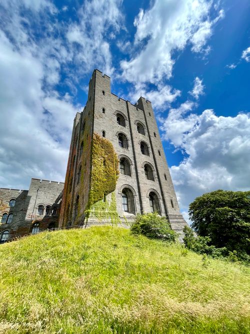 Free Stunning view of Penrhyn Castle's facade and lush greenery in Wales during summer. Stock Photo