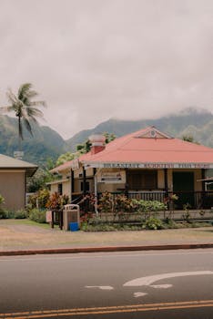 A quaint restaurant with lush mountains in the backdrop, embodying serene countryside vibes.