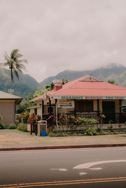 Photo by Juan Gomez A quaint restaurant with lush mountains in the backdrop, embodying serene countryside vibes.