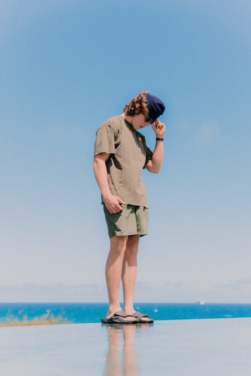 Young Man in Casual Clothing on the Background of the Sea 