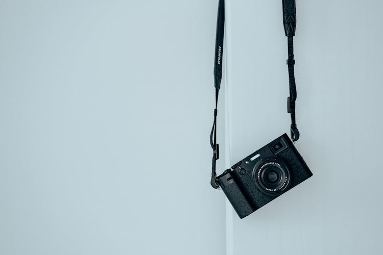 Camera Hanging On White Wall