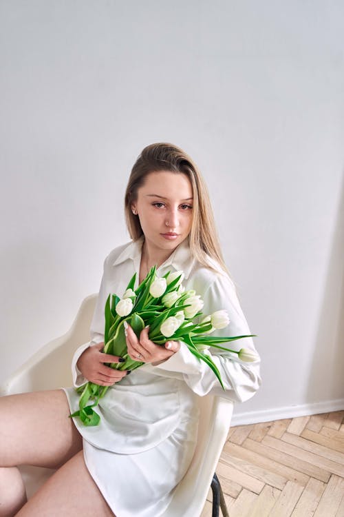 A Woman Holding a Bouquet of White Flowers