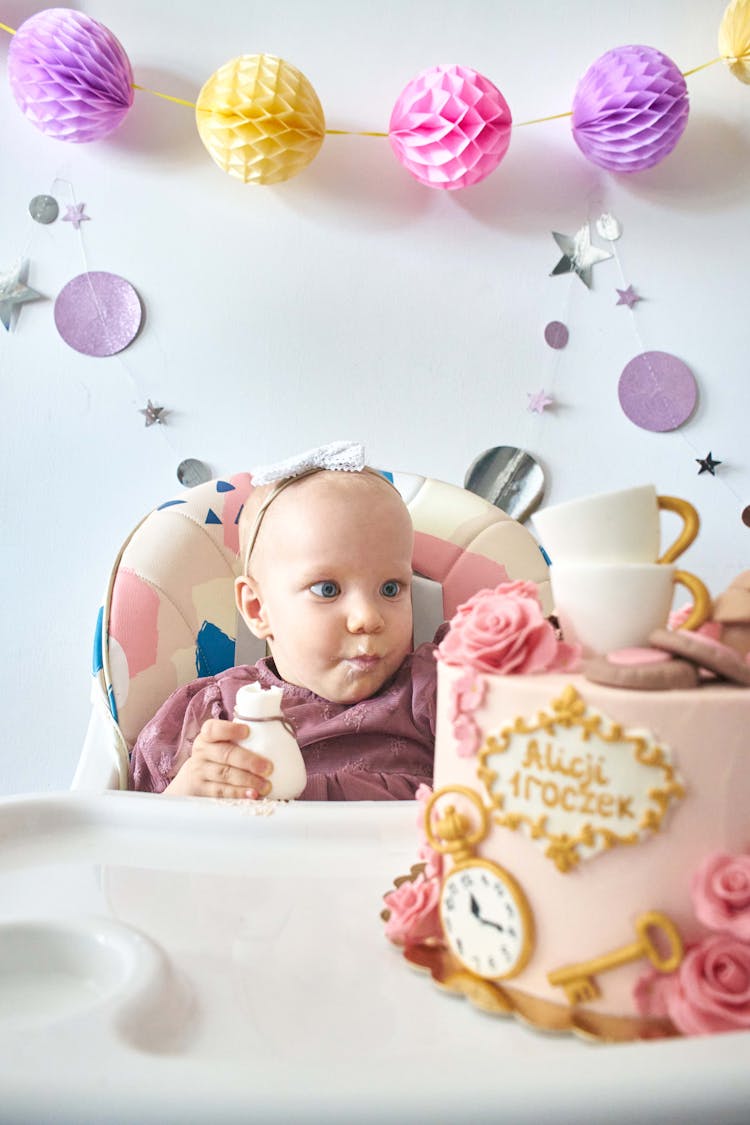 Baby Staring At Her Birthday Cake