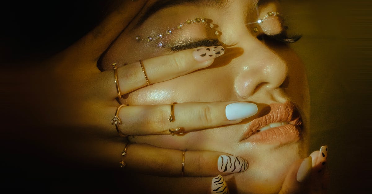Close-up of Woman Showing Nails Design on Face