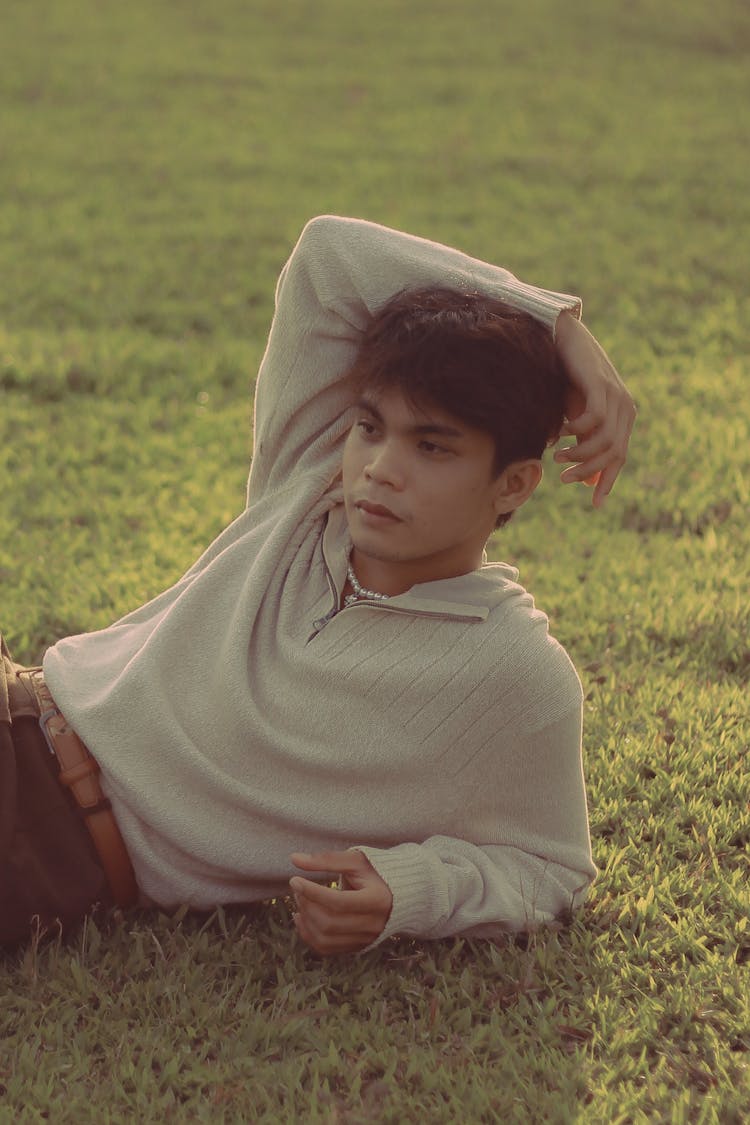 Young Man Lying On Grass