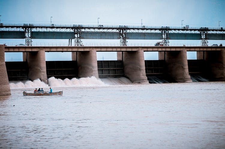 People In Boat Near Water Dam