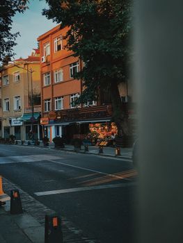 Street view of urban area with market and buildings under warm sunset light.