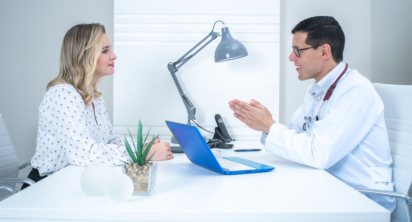 A doctor conducts a patient consultation in a bright, modern medical office. — illustrative stock photograph