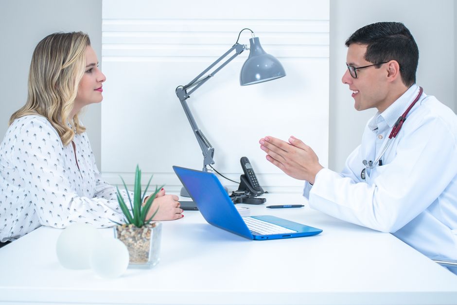 Doctor in consultation with a patient reviewing medical history — iboga ceremony requires full medical screening and a no is sometimes the outcome of that process
