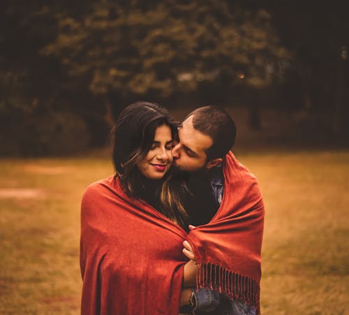 A Man Kissing a Woman