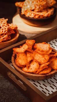 Close-up of spicy Indonesian snacks presented in ceramic bowls with a rustic vibe. - Fotografer Sidoarjo