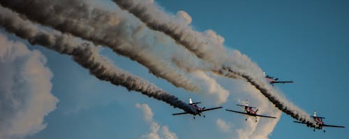 Four Flying Airplanes With Contrails