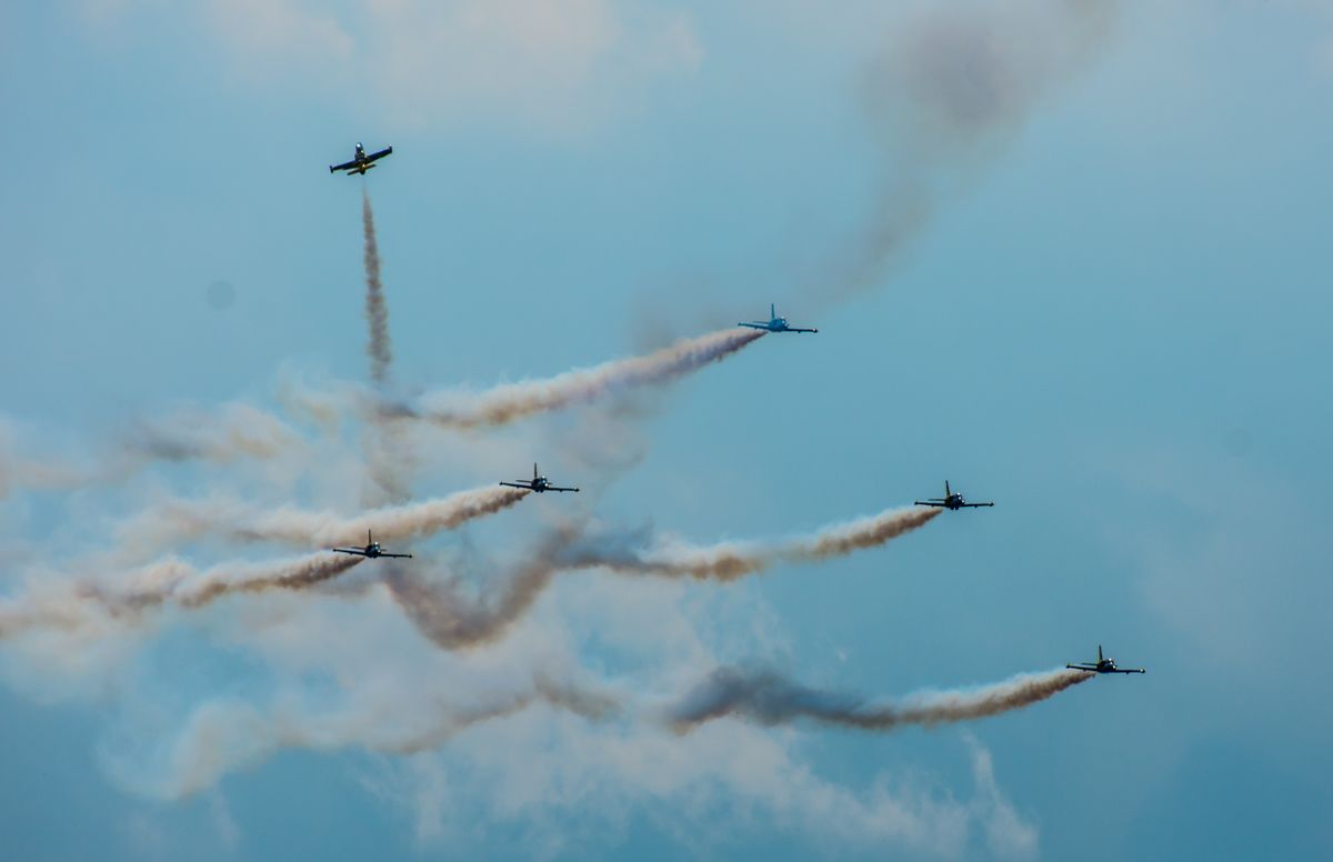 Six jet aircraft crossing at an airshow — female Blue Angel pilots breaking barriers