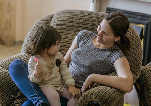 A Mother Sitting on a Couch with Her Daughter